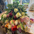 Bouquet of colorful tulips on a table with a window in the background