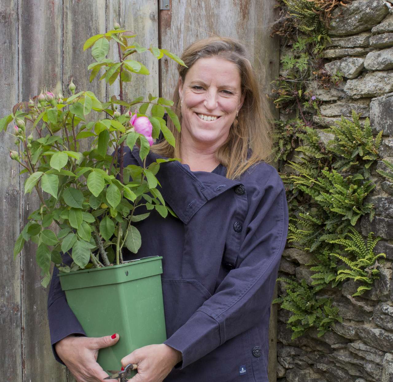 Rachel Golding-Barrett of The Tetbury Flower Company holds a pink rose